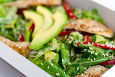 Paketinde avokado olan tavuk salatası. Sağlıklı öğle yemeği