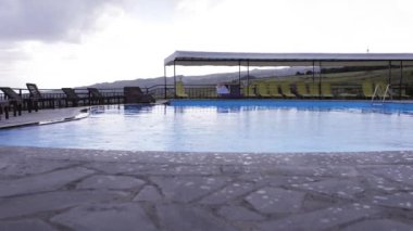 Rainy day at the hotel pool. Spoiled vacation