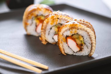 Pilavlı suşi, yengeç, salatalık, avokado, tobiko, yılan balığı. Suşi menüsü. Japon yemeği..