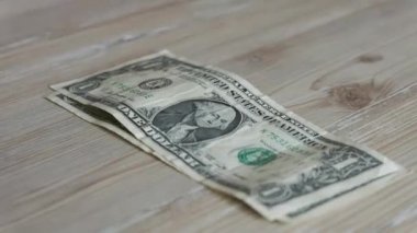 Little boy counts his one dollar bills