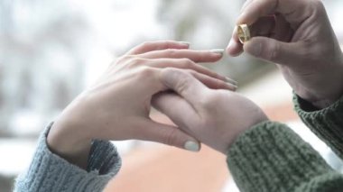 Man puts a ring on his loved one's finger