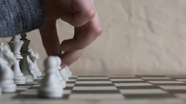 Boy playing chess in the room. Little clever boy  playing chess at home.