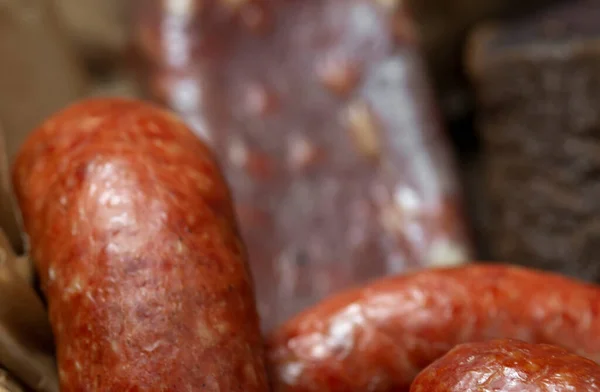 Cold meats, smoked and cured sausage, smoked meat, sausage in  wooden box. rustic style .