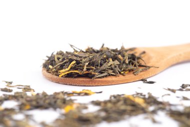 beyaz arka plan üzerinde izole ahşap bir kaşık üzerinde aromatik yeşil kuru çay,