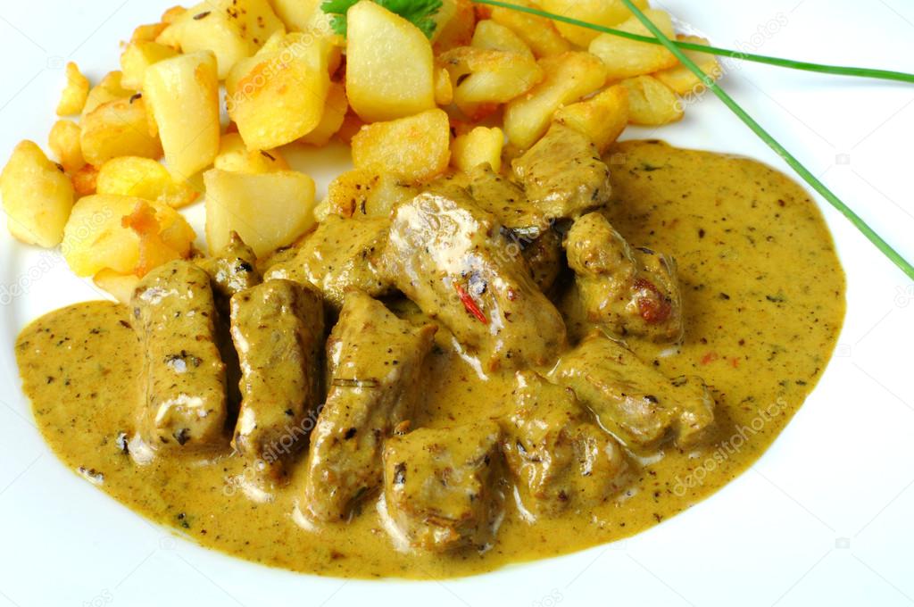 Marinated beef in coconut milk with fried potatoes
