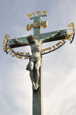 17th Century Crucifixion statue with Hebrew lettering in Charles Bridge Prague