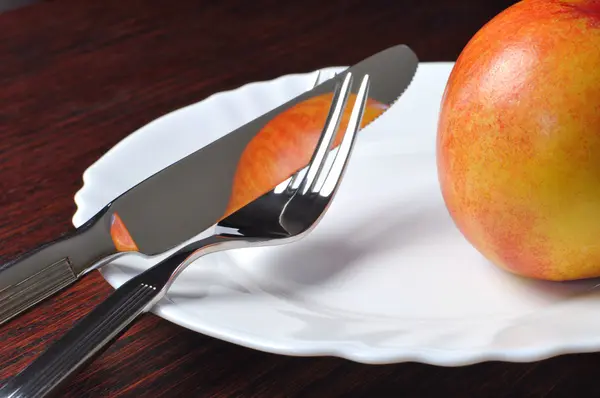 Cutlery and nectarine Royalty Free Stock Photos