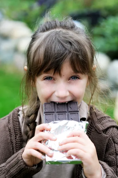 Little cute girl eating chocolate — Stock Photo, Image