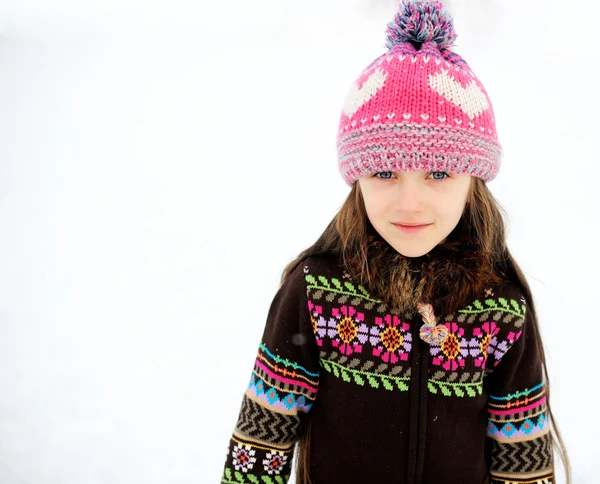 Adorable smiling child girl in pink knitted hat — Stock Photo, Image