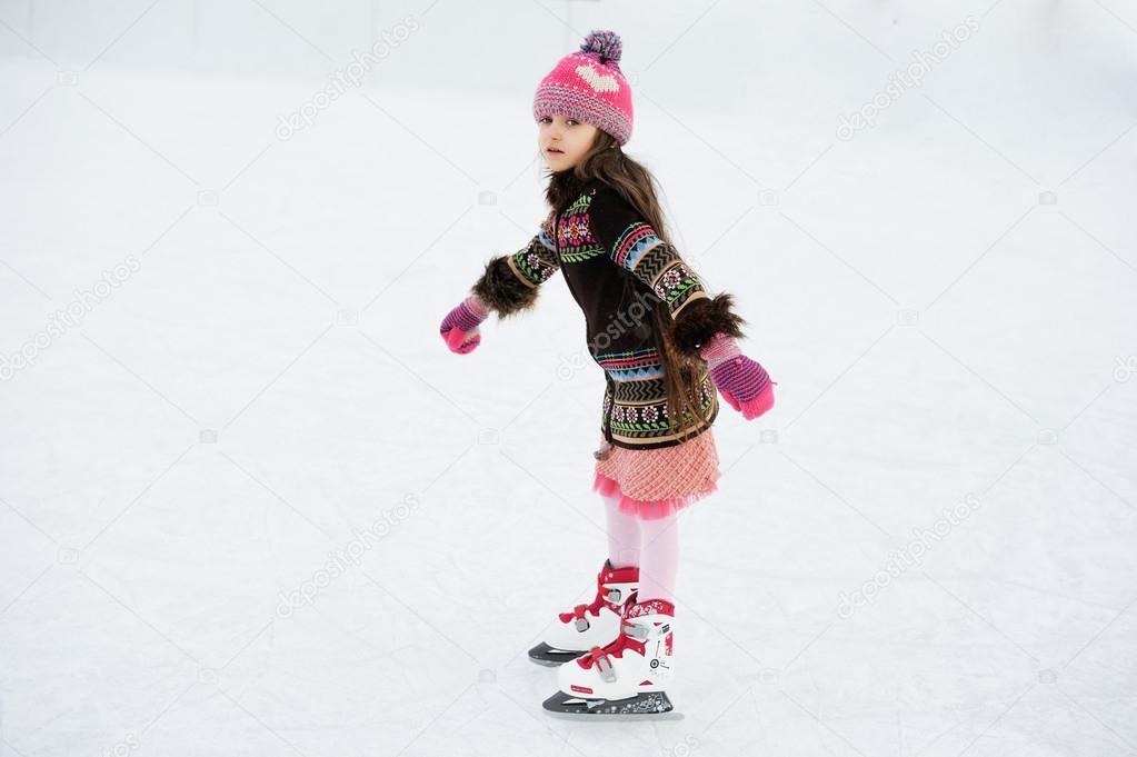 Winter portrait of ice skating child girl