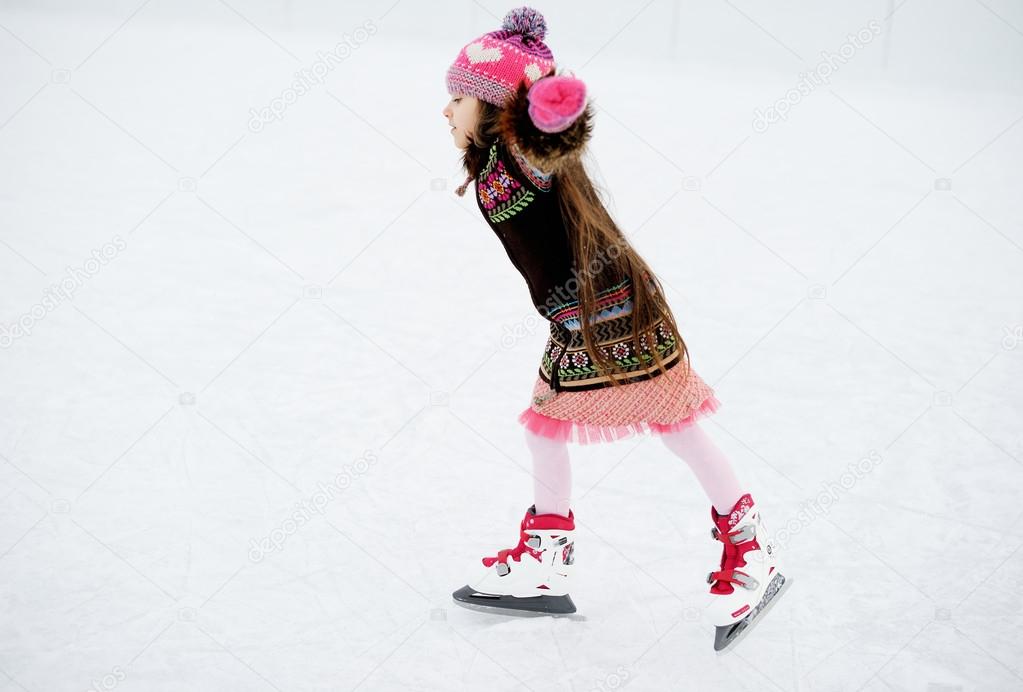 Winter portrait of ice skating child girl