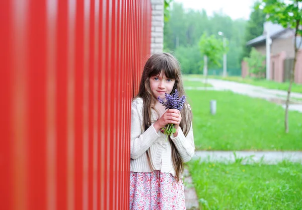 Elégante fille enfant posant avec un bouquet de fleurs — Photo