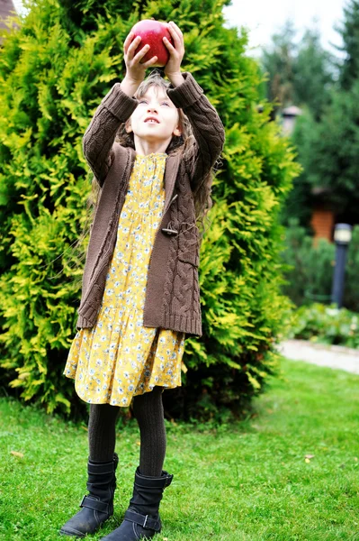 Child girl holding big apple — Stock Photo, Image