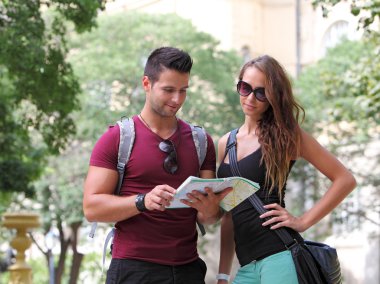 Young couple watching the city map