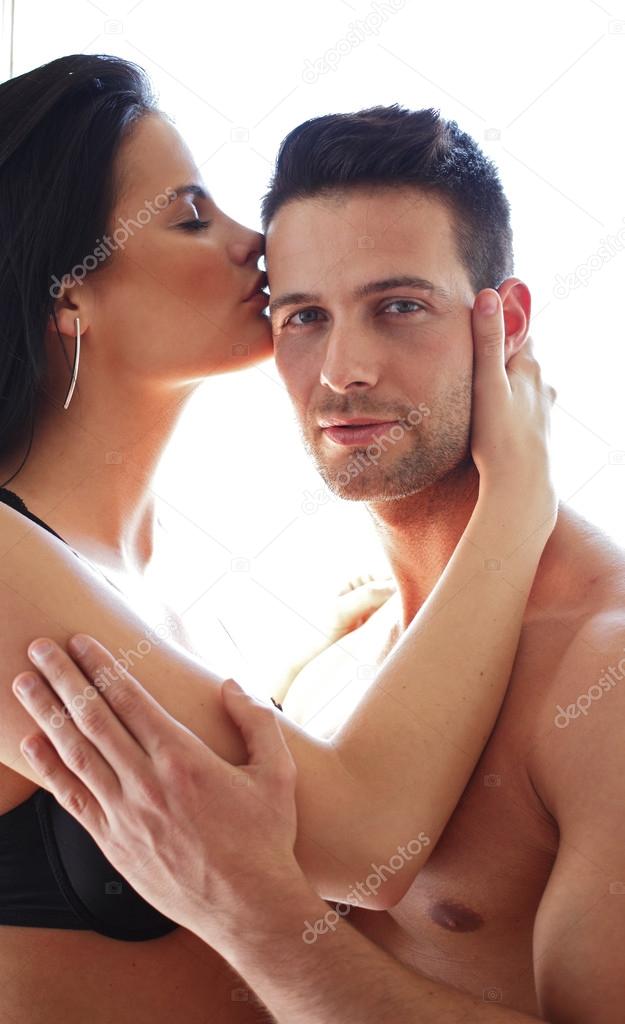 Man holding his kissing girlfriend
