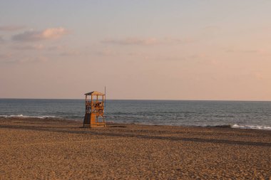 Beach guard tower in Alanya, Turkey. Sunset view of Mediterranean sea.