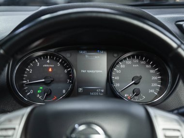 Novosibirsk, Russia - November 04, 2021: Nissan Qashqai ,  black car speedometer. Close up shot of the dashboard a car. clipart