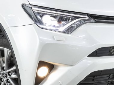 Novosibirsk, Russia - November 04, 2021:  Toyota RAV-4,  Close up of the car headlights. Exterior closeup detail