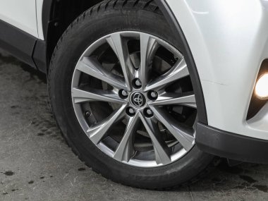 Novosibirsk, Russia - November 04, 2021:  Toyota RAV-4,  close up of the car front detail with  light-alloy wheel