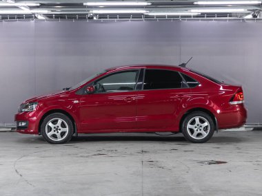 Novosibirsk, Russia - November 18, 2021:   Volkswagen Polo, side view. Red sedan  on a parking   