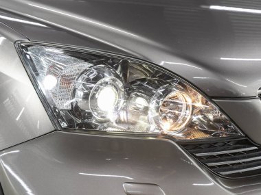 Novosibirsk, Russia - November 11, 2021:   Honda CR-V  ,  Close up of the car headlights. Exterior closeup detail