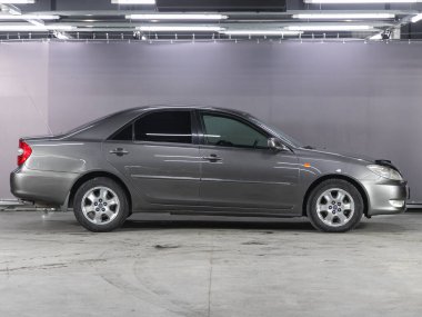 Novosibirsk, Russia - December    01 , 2021:  silver Toyota Camry, side view.  Photography of a modern sedan  made in Japan on a parking in Novosibirsk