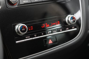 Novosibirsk, Russia - October   31 , 2021:  Mitsubishi Outlander, Black  detail with the air conditioning button inside a car.