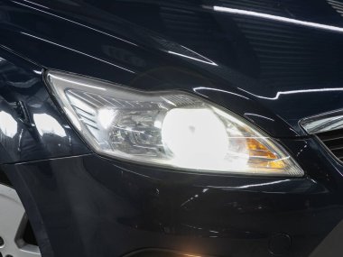 Novosibirsk, Russia - December    01 , 2021:  Ford Focus,  Close up of the car headlights. Exterior closeup detail
