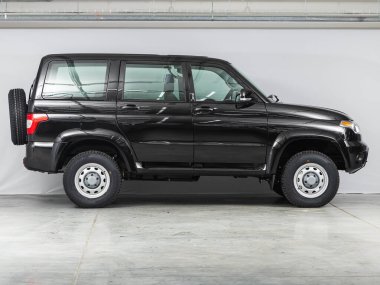 Novosibirsk, Russia - October    24 , 2021: black   UAZ Patriot, side view.  Photography of a modern sedan  made in Russia on a parking 