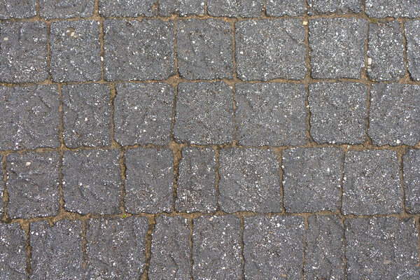 The wall is paved with gray stones, top view. stone texture, outdoor stone tiles