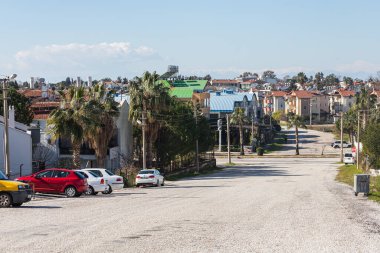Yana, Türkiye - 20 Ocak 2022: Arka planda farklı alçak binalar, arabalar ve dağ bulunan şehir caddesi 