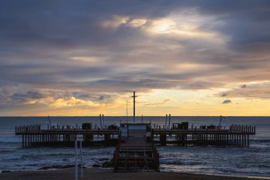 Güzel deniz pantonu ve plaj. Otelin kumlu sahilinde büyük bir ahşap iskele var. Uzun pantolonlu güzel tropikal sahil manzarası. Deniz kıyısının manzarası