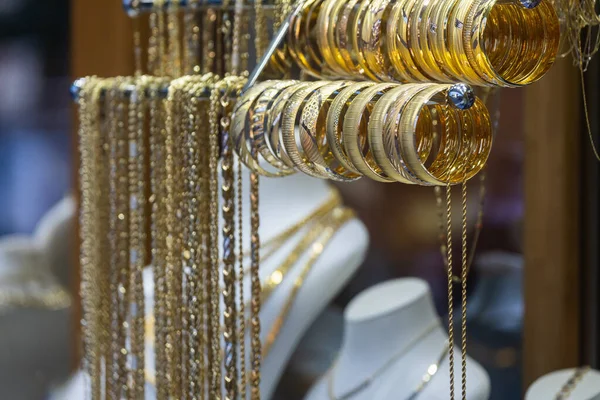 Jewelry shop window with a huge selection of gold jewelry bracelets, chains, rings