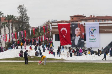 Manavgat, Türkiye - 29 Ocak 2022: Şehir Kar Festivali. Ailesi olan çocuklar kar dağında eğlenir, tepeden aşağı kayarlar.