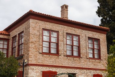 Türkiye 'de kırmızı çatılı eski antik evin manzarası. Tarafı Türkiye 'de daha popüler bir turizm beldesi.