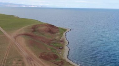 Cinematic aerial view of the high mountains of Siberia. The famous Lake Baikal. Beautiful nature of Asia Russia. Sunny day . 4K drone shooting
