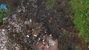There is a lot of rubbish in the forest. The concept of anthropogenic pollution of forests and nature. Scary trash heap in the forest. Near Baikal