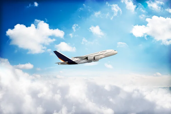 Jet airplane peaking through the clouds Stock Picture