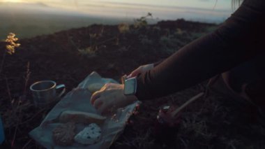 Climber preparing food on mountain top in mexico