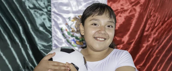 Little girl covered with a mexican flag