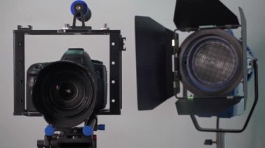 Camera in a photo studio with backdrop and light equipment. High quality 4k footage