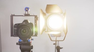 Camera in a photo studio with backdrop and light equipment. High quality 4k footage