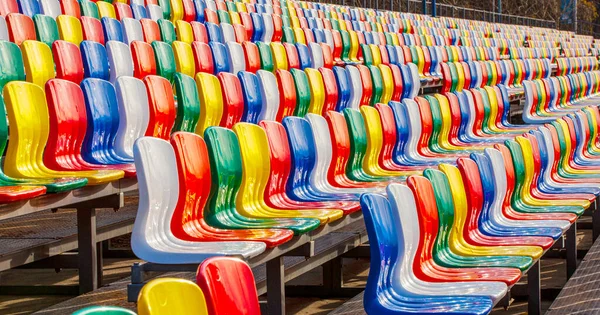 Rader av färgade plastsäten på stadion — Stockfoto
