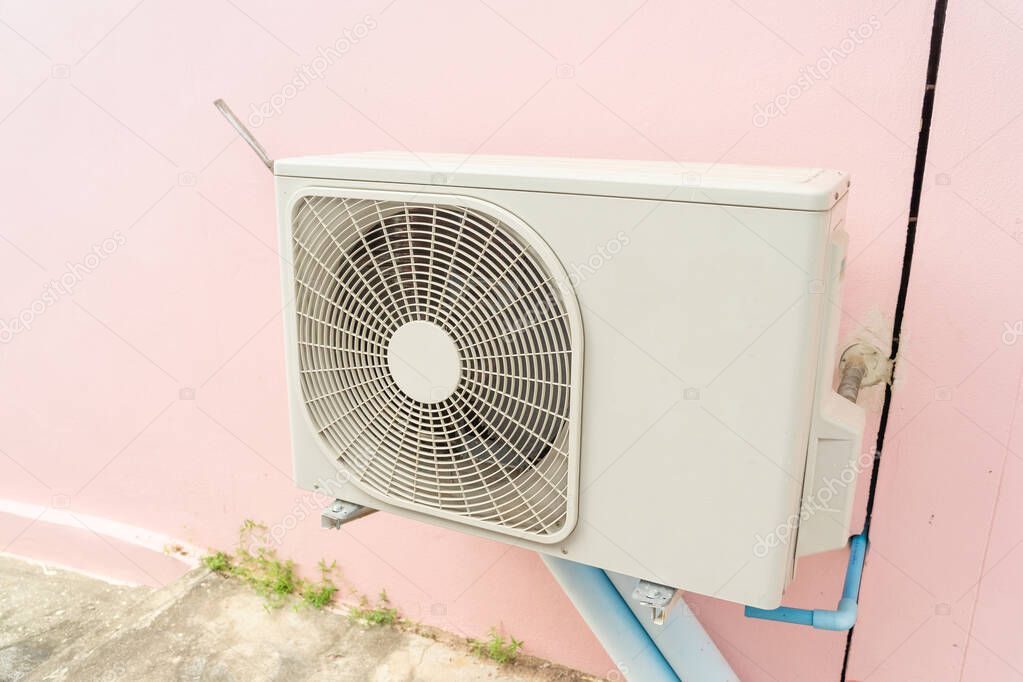 Condensing unit of air conditioning systems on wall.