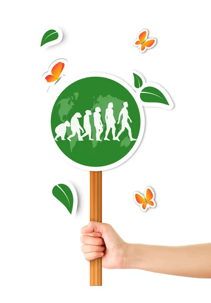 Hand holding green world sign with evolution man — Stock Photo, Image