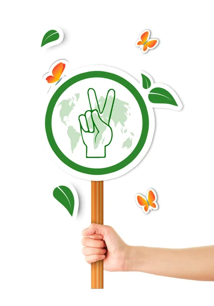 Mano sosteniendo verde signo de paz mundial — Foto de Stock