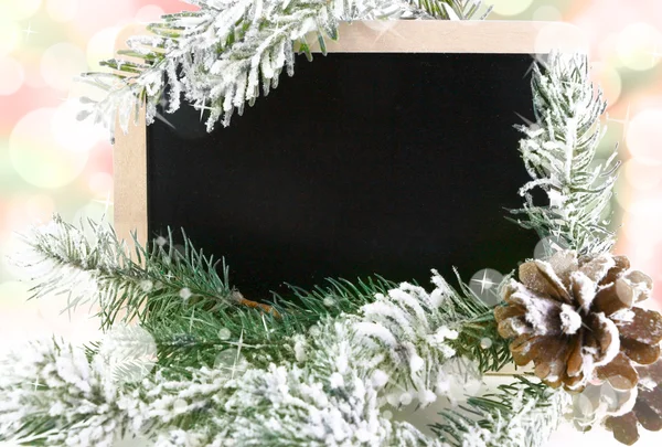 Pizarra vacía con árbol de Navidad nevado y fondo bokeh —  Fotos de Stock