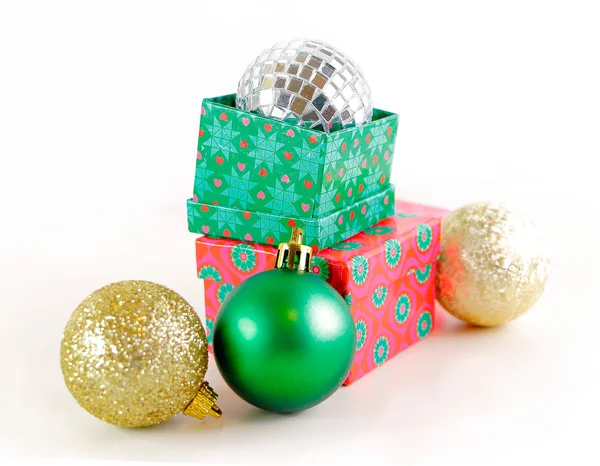 Presents with Christmas balls isolated on white — Stock Photo, Image