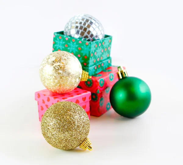 Presents with Christmas balls isolated on white — Stock Photo, Image