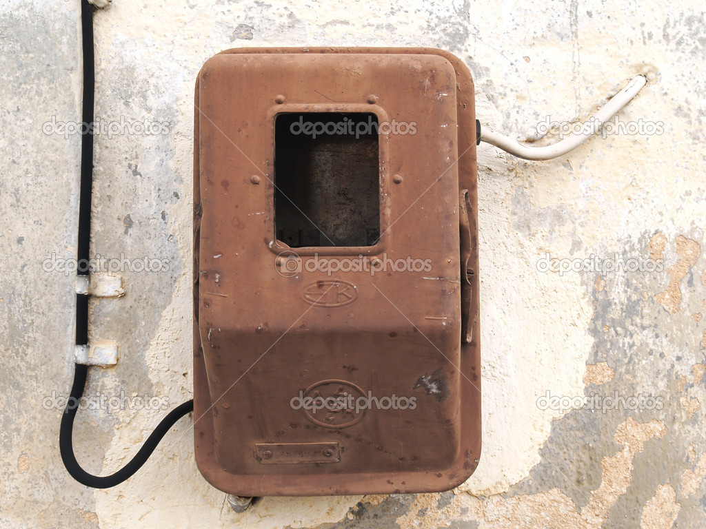 Old electric meter on grungy aged wall
